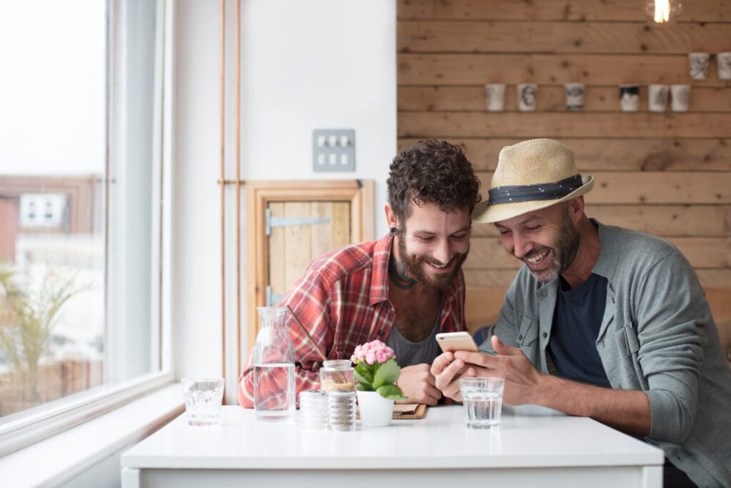 Couple using QO Direct on their phones to easily apply for a mortgage