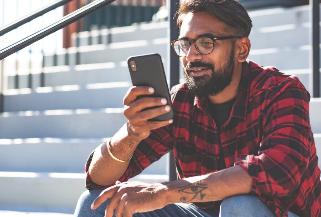 Man using QO Direct app on phone to quickly apply for a mortgage loan