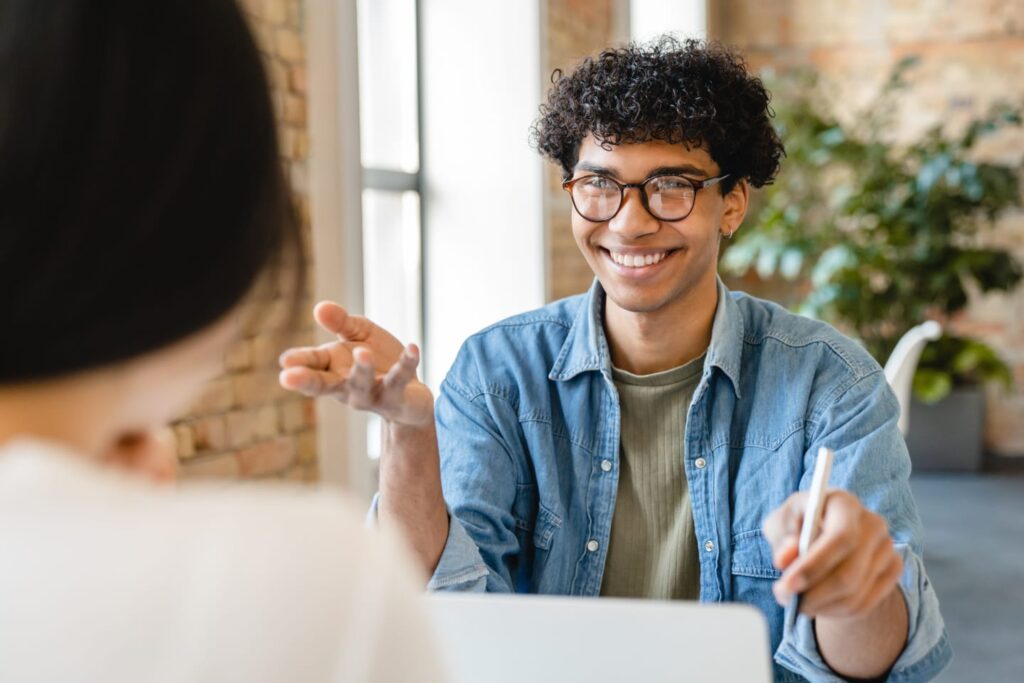 A man is discussing a government mortgage loan with a woman in an office