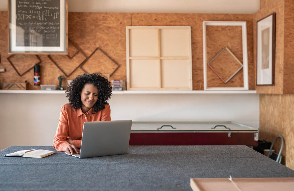 Woman applying for a bank statement loan from Quaint Oak Mortgage on a laptop