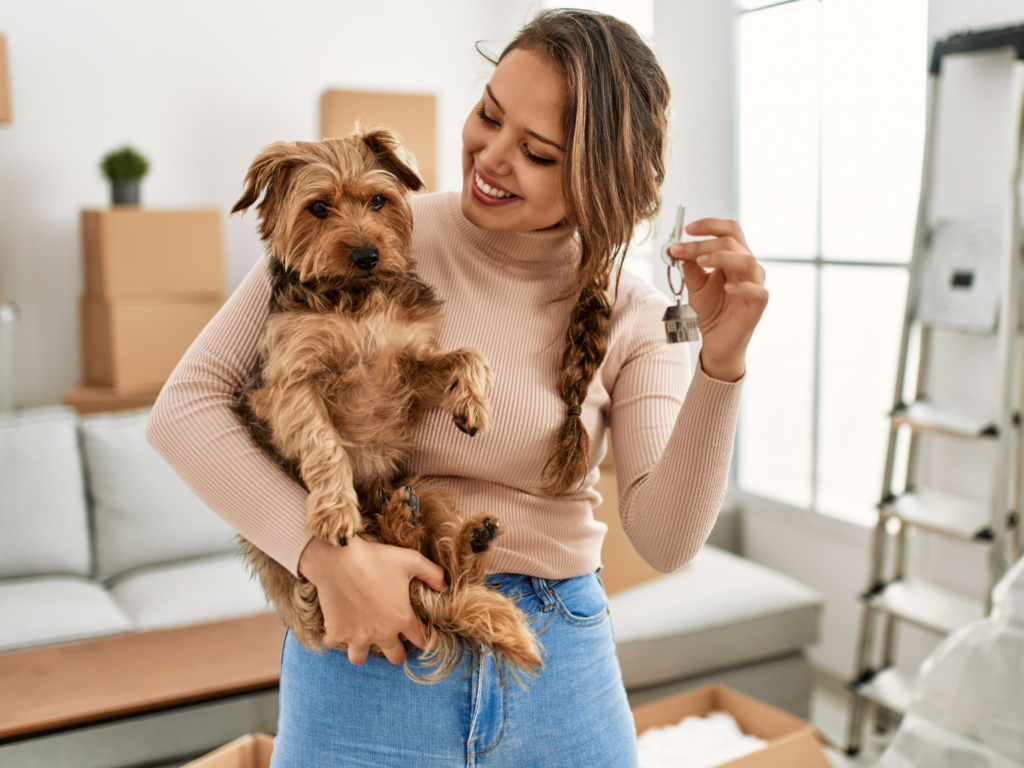 female homebuyer and her dog moving in to home purchased with the benefits of FHA loans