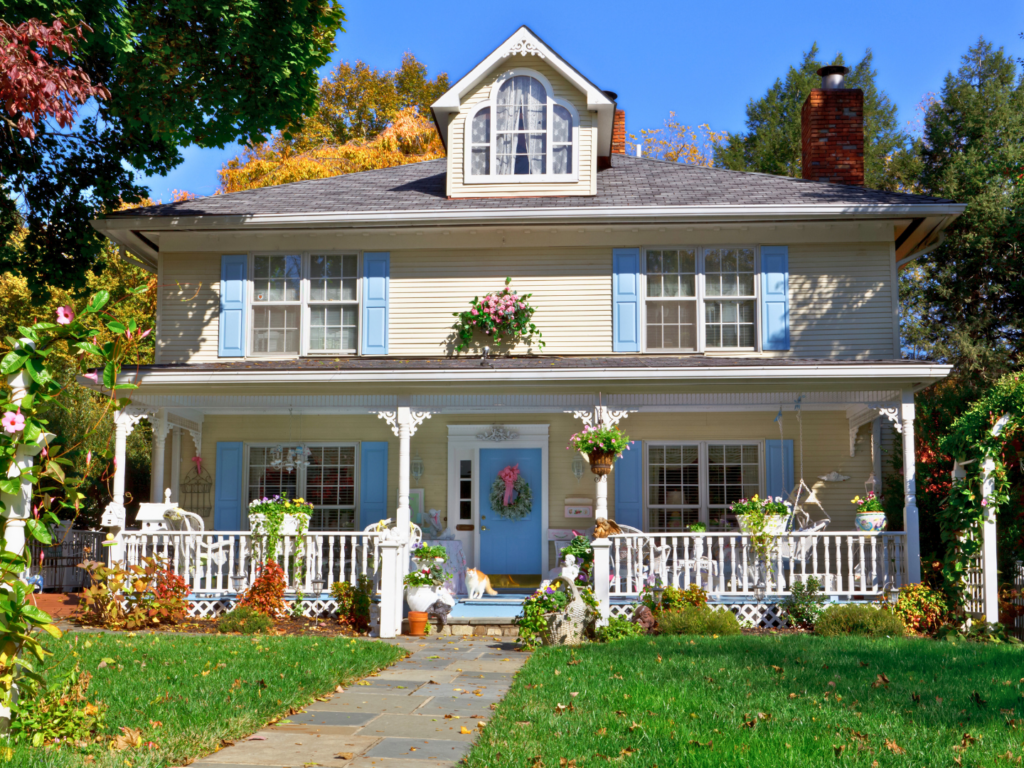 a yellow and blue farmhouse in the spring purchased with a homeready loan