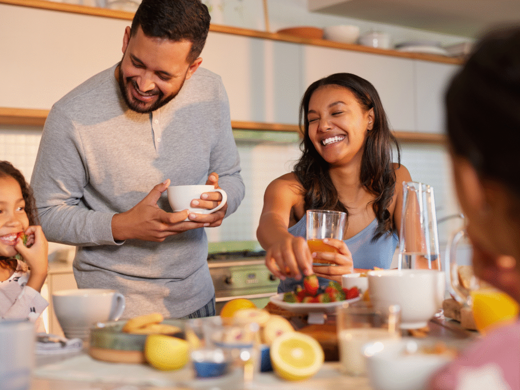 a family at home eating breakfast in a home refinanced after learning how credit scores affect refinance rates